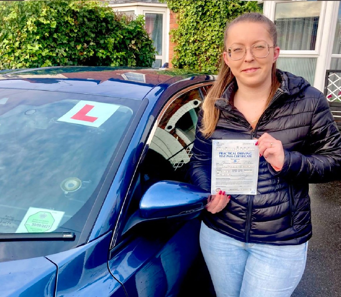 Bianca-Teodora P. holding her practical driving test pass certificate