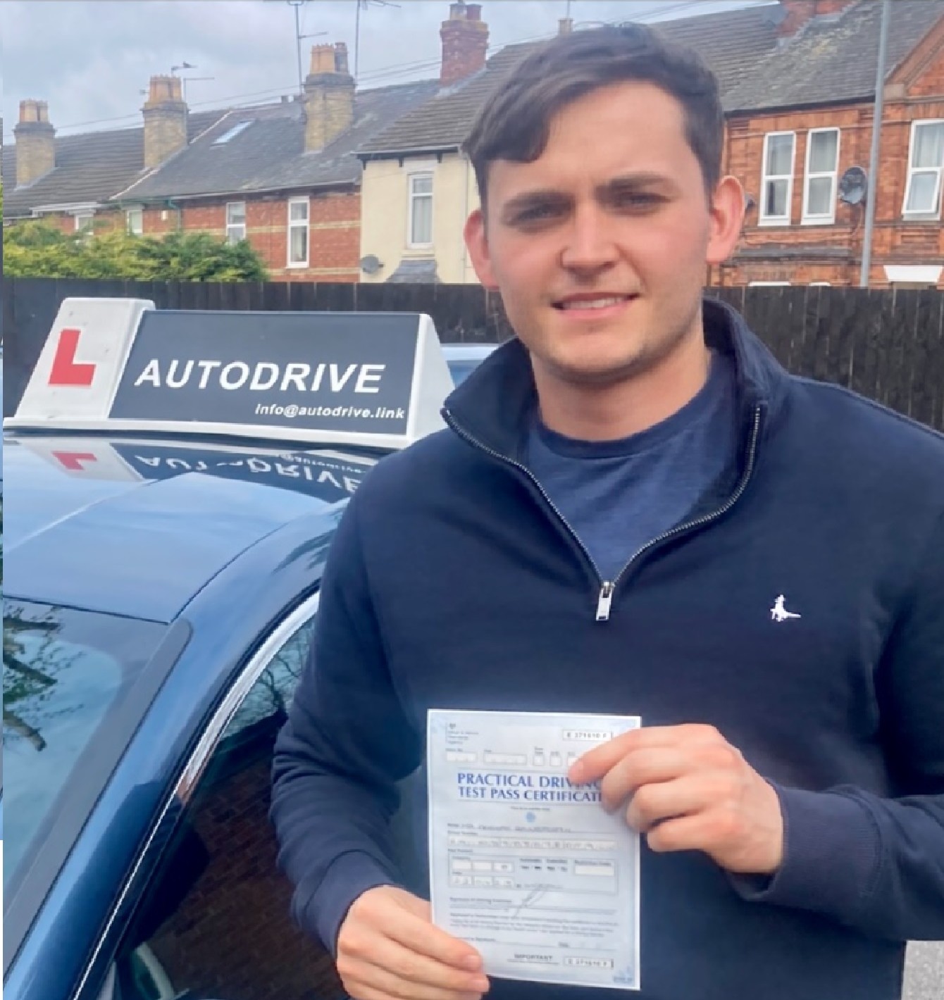 Declan R. holding his practical driving test pass certificate