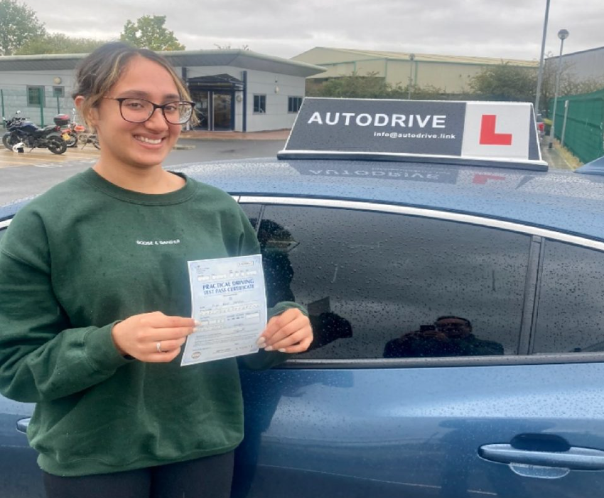 Kaya K. holding her practical driving test pass certificate