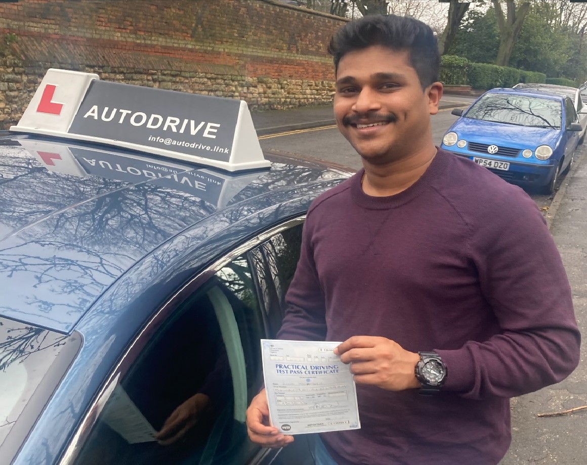 Lino M. holding his practical driving test pass certificate