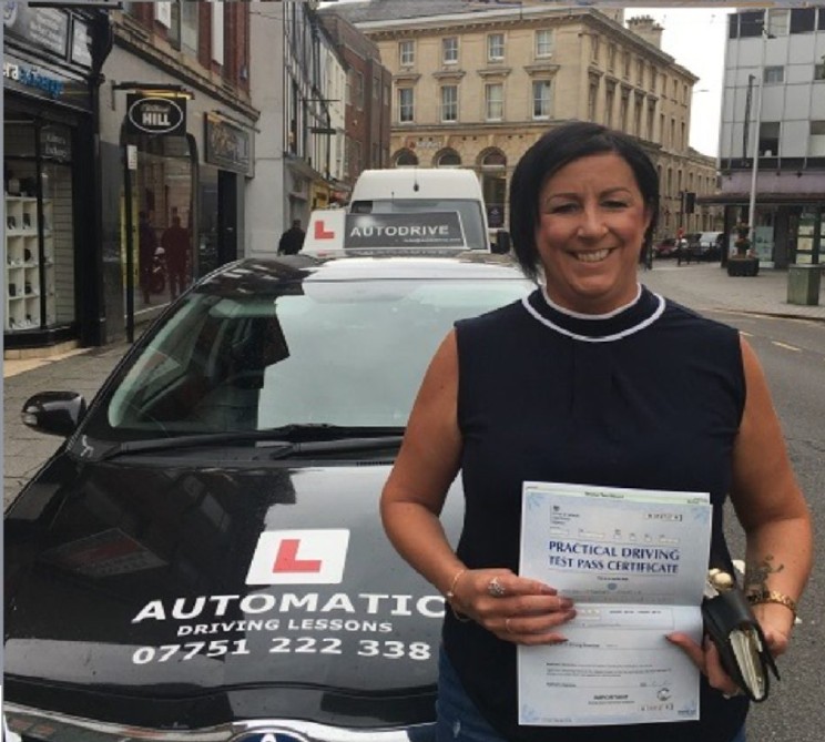 Tanya C. holding her practical driving test pass certificate