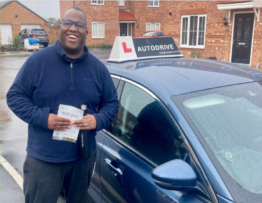 Tim B. holding his practical driving test pass certificate