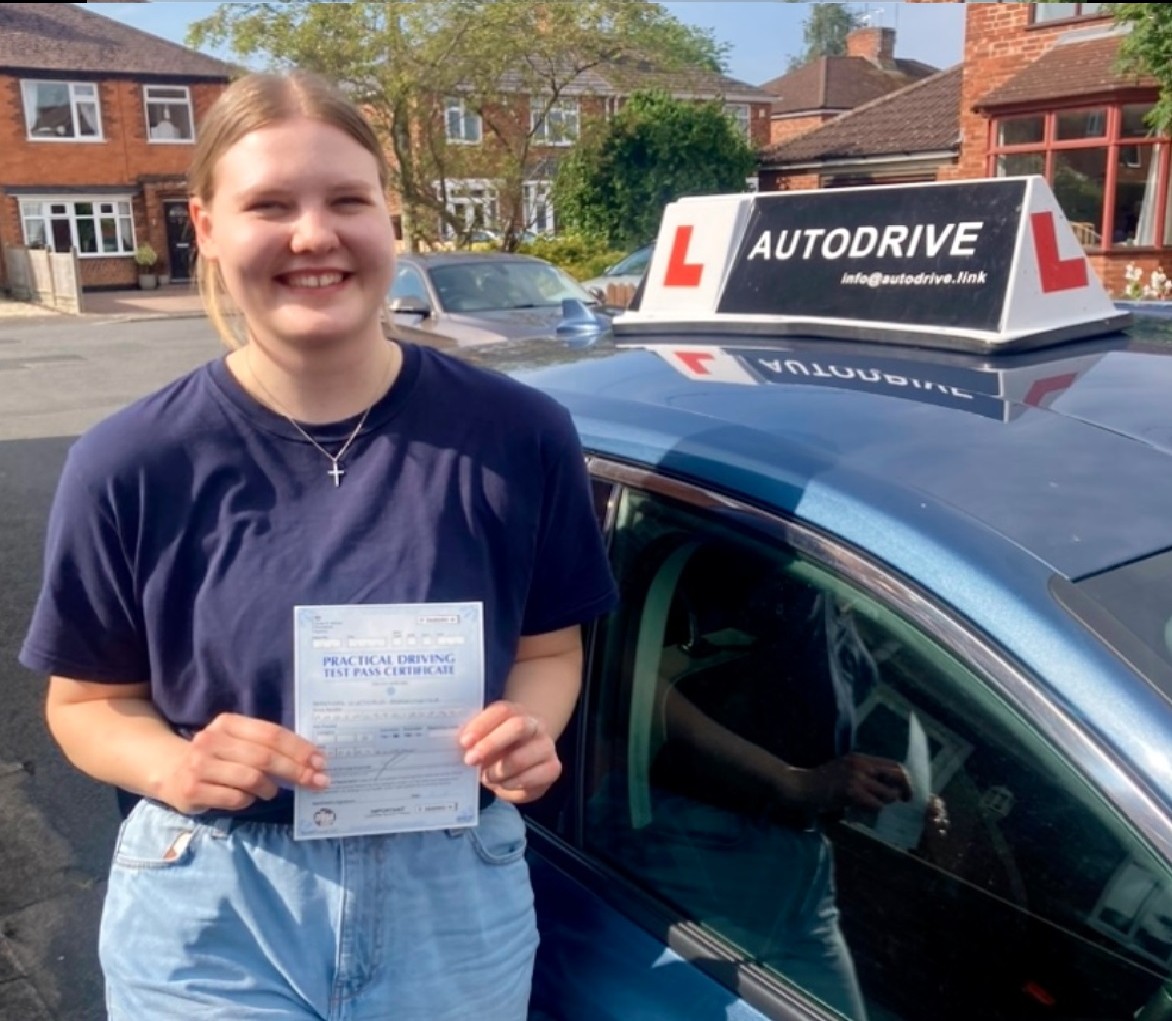 Viktoria R. holding her practical driving test pass certificate