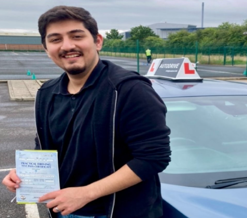 Zaid M. holding his practical driving test pass certificate